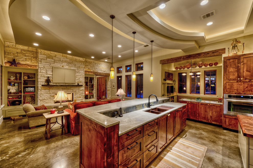 Example of a large classic u-shaped concrete floor and gray floor open concept kitchen design in Austin with two islands, an undermount sink, dark wood cabinets, marble countertops, multicolored backsplash, flat-panel cabinets, slate backsplash, stainless steel appliances and gray countertops