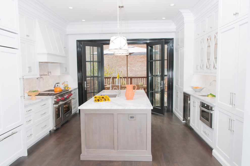 Mid-sized trendy galley dark wood floor eat-in kitchen photo in New York with an undermount sink, flat-panel cabinets, white cabinets, quartz countertops, beige backsplash, stone tile backsplash, stainless steel appliances and an island