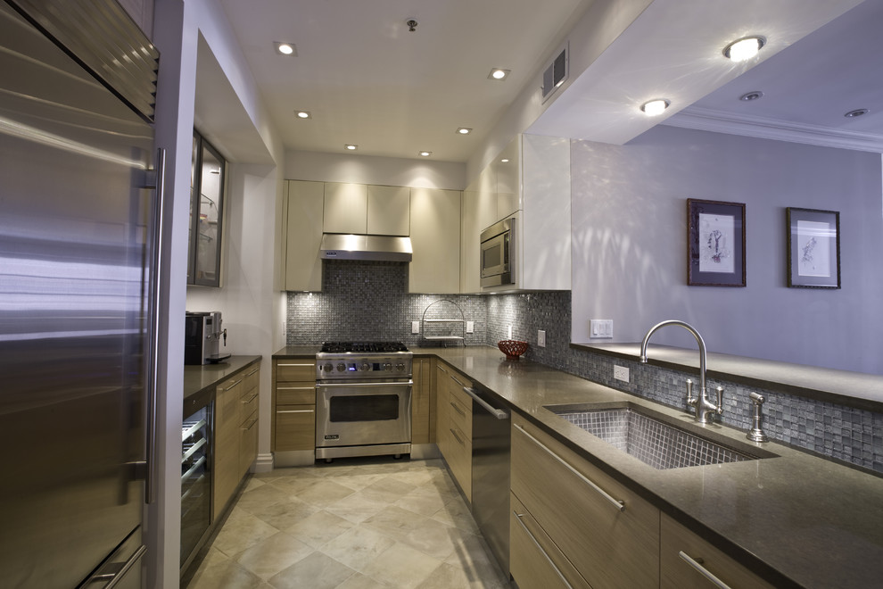 This is an example of a contemporary u-shaped kitchen in New York with stainless steel appliances, a single-bowl sink, flat-panel cabinets, medium wood cabinets, blue splashback and mosaic tiled splashback.