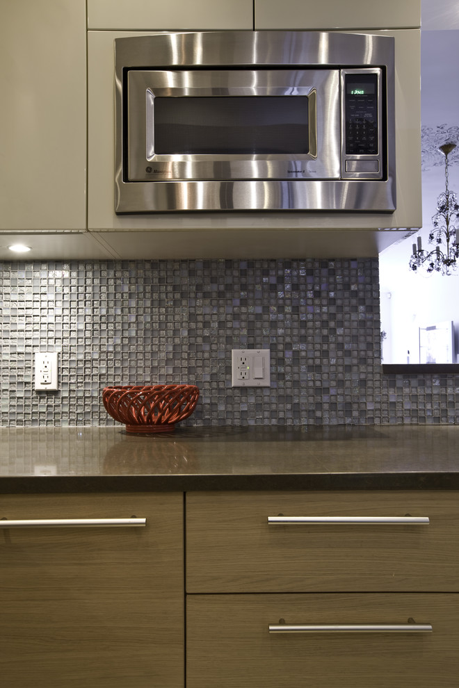 Moderne Küche mit Küchengeräten aus Edelstahl, Küchenrückwand in Blau, Rückwand aus Mosaikfliesen und flächenbündigen Schrankfronten in New York