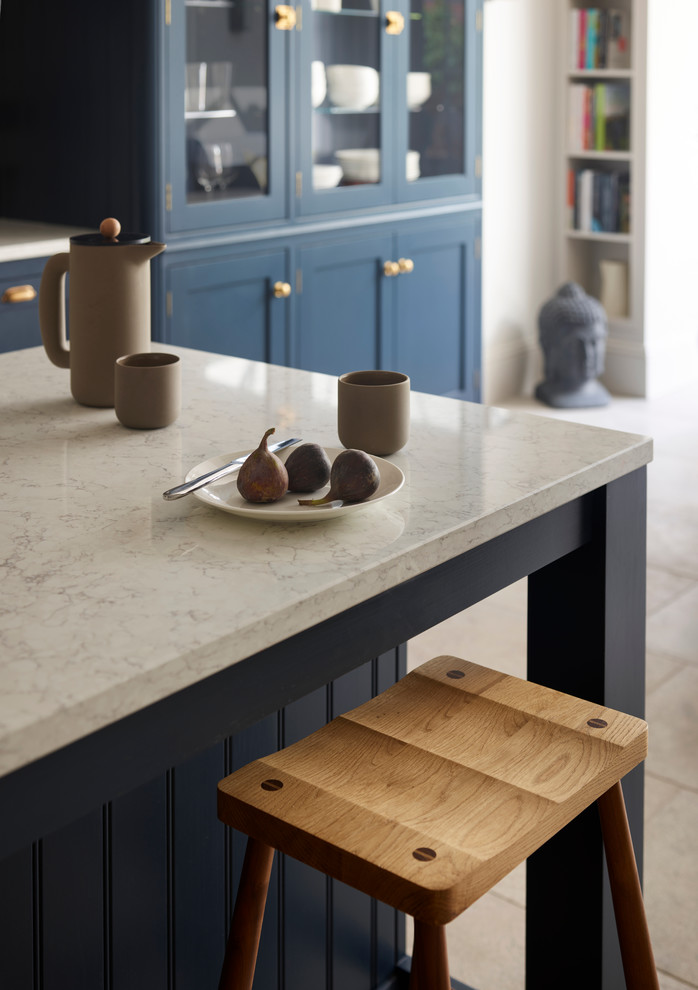 Example of a mid-sized transitional kitchen design in Sussex with a farmhouse sink, white backsplash, subway tile backsplash, stainless steel appliances and an island