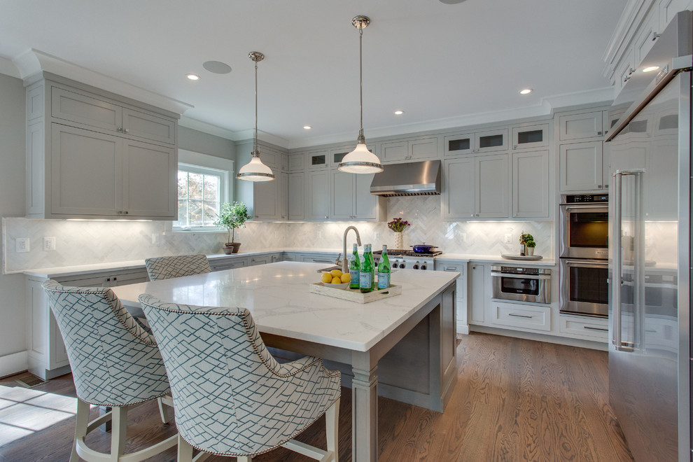 Open concept kitchen - huge transitional u-shaped medium tone wood floor and brown floor open concept kitchen idea in DC Metro with a single-bowl sink, shaker cabinets, gray cabinets, quartz countertops, white backsplash, marble backsplash, stainless steel appliances and an island