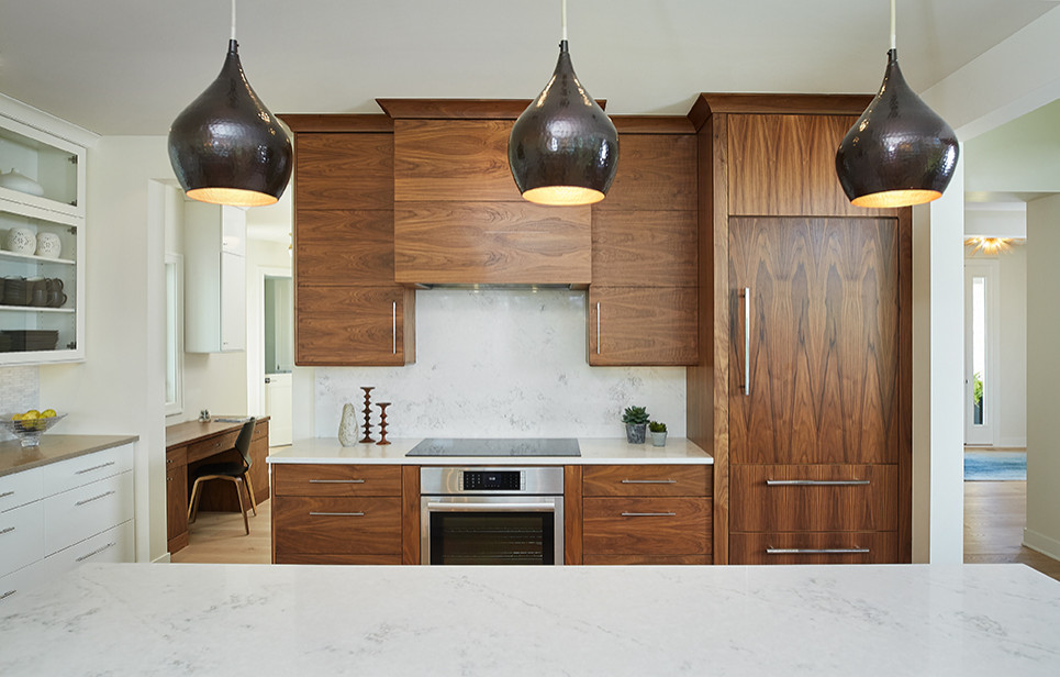Example of a large mid-century modern l-shaped light wood floor and brown floor open concept kitchen design in Grand Rapids with an undermount sink, flat-panel cabinets, dark wood cabinets, quartz countertops, white backsplash, marble backsplash, stainless steel appliances, an island and white countertops