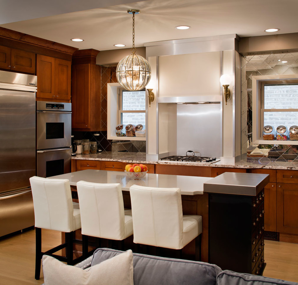 Mid-sized transitional u-shaped light wood floor eat-in kitchen photo in Chicago with a drop-in sink, marble countertops, white backsplash, stainless steel appliances and an island