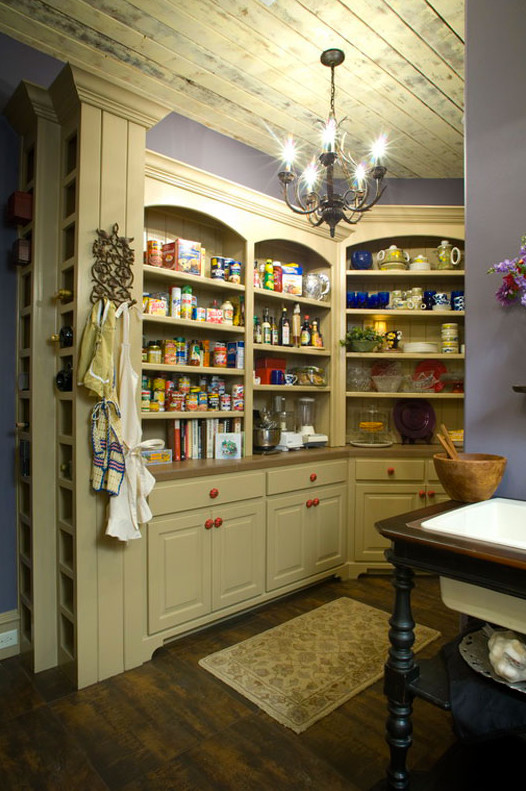 Photo of a medium sized rural kitchen pantry in Orange County with raised-panel cabinets, white cabinets, dark hardwood flooring and a built-in sink.