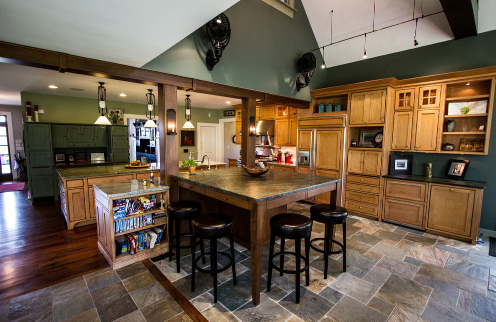 Example of a classic u-shaped slate floor open concept kitchen design in Indianapolis with a farmhouse sink, shaker cabinets, light wood cabinets, granite countertops, white backsplash, subway tile backsplash and paneled appliances