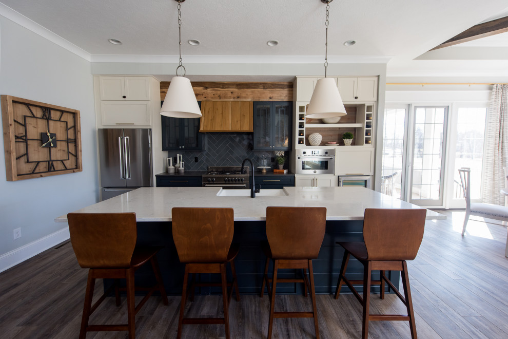 Inspiration for a mid-sized contemporary l-shaped dark wood floor open concept kitchen remodel in Indianapolis with an undermount sink, shaker cabinets, white cabinets, quartz countertops, gray backsplash, ceramic backsplash, stainless steel appliances, an island and white countertops