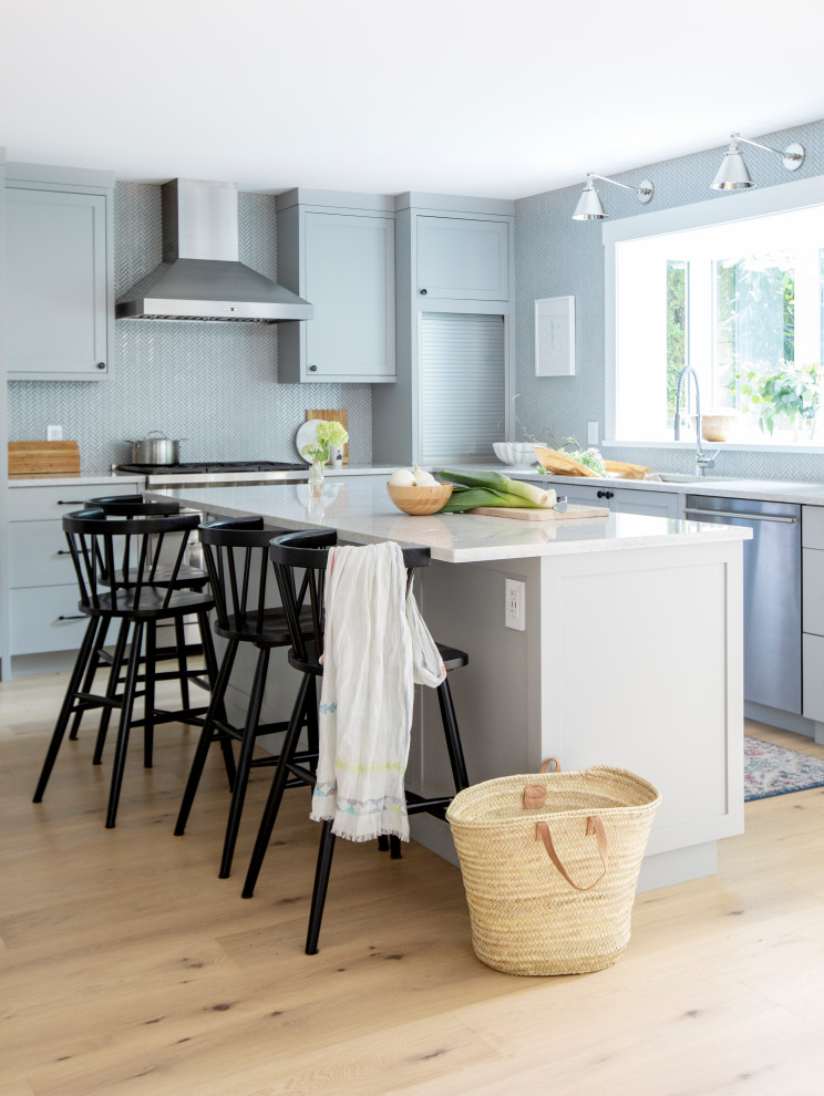 Inspiration for a large transitional l-shaped light wood floor and beige floor eat-in kitchen remodel in Vancouver with an undermount sink, shaker cabinets, gray cabinets, quartz countertops, gray backsplash, porcelain backsplash, paneled appliances, an island and white countertops