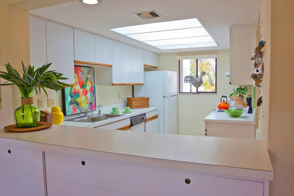 Kitchen pantry - small tropical galley kitchen pantry idea in Miami with flat-panel cabinets and white cabinets