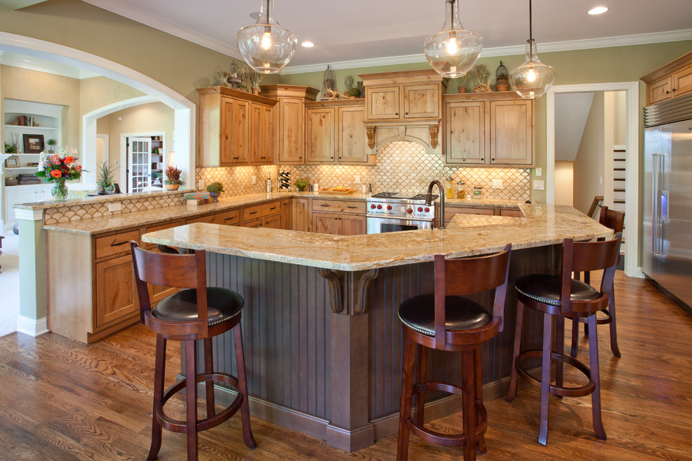 This is an example of a traditional kitchen in Cincinnati with shaker cabinets, medium wood cabinets, granite worktops, beige splashback and stainless steel appliances.
