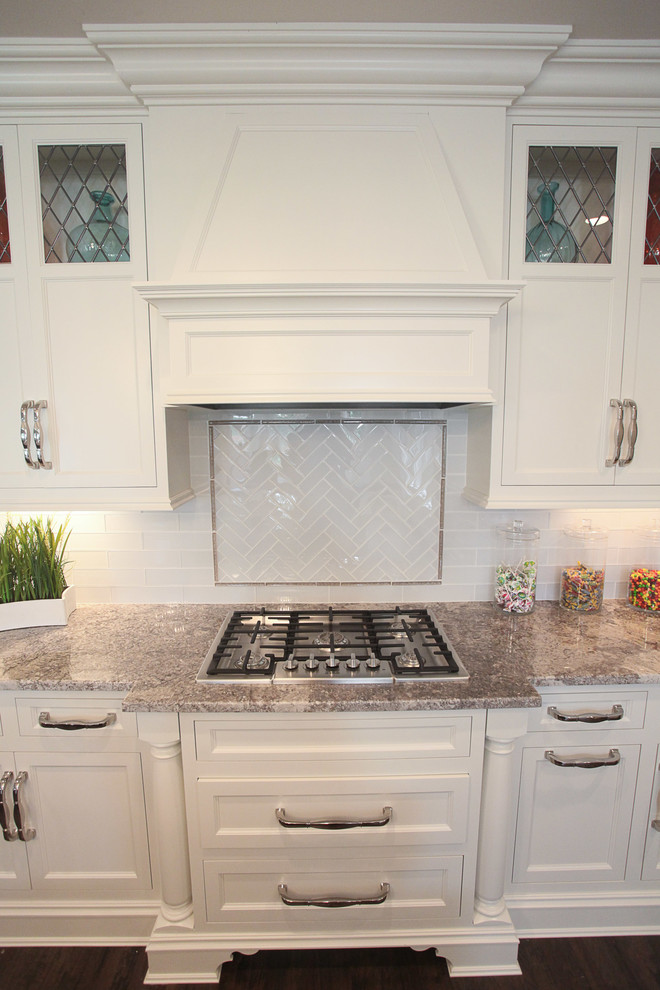 Example of a large classic eat-in kitchen design in Louisville with a farmhouse sink, subway tile backsplash, stainless steel appliances and an island