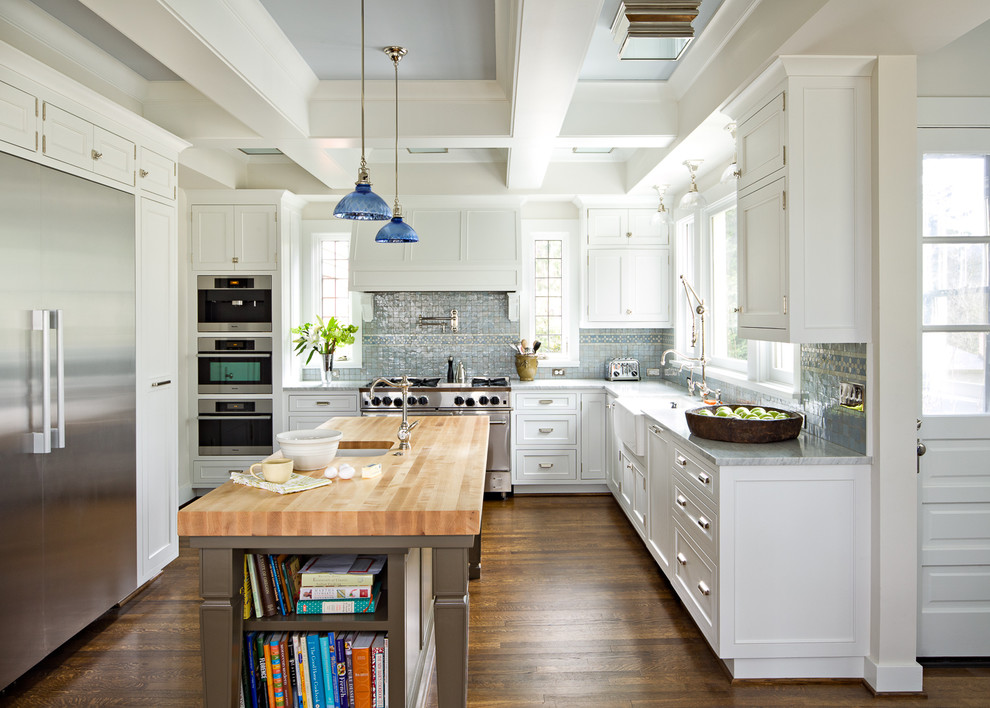 ポートランドにあるトラディショナルスタイルのおしゃれなL型キッチン (シルバーの調理設備、木材カウンター、エプロンフロントシンク、落し込みパネル扉のキャビネット、白いキャビネット、青いキッチンパネル) の写真
