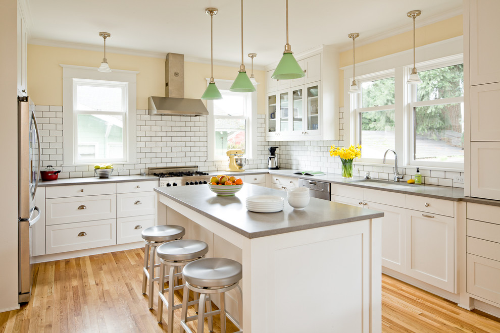 Trendy u-shaped kitchen photo in Portland with subway tile backsplash, an undermount sink, white cabinets and white backsplash
