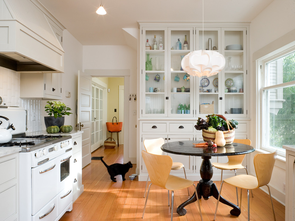 Example of a trendy enclosed kitchen design in Portland with white appliances, beaded inset cabinets, white cabinets, white backsplash and subway tile backsplash