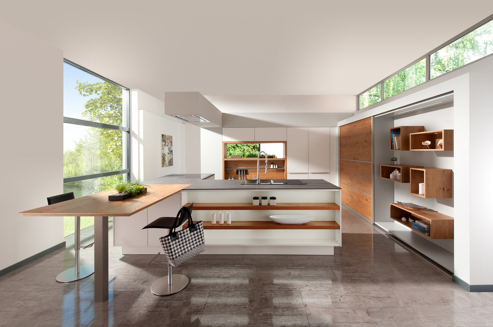 Design ideas for a modern u-shaped kitchen/diner in Miami with a built-in sink, flat-panel cabinets, white cabinets, engineered stone countertops and stainless steel appliances.