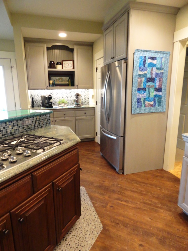 Large beach style u-shaped dark wood floor eat-in kitchen photo in Seattle with flat-panel cabinets, distressed cabinets, granite countertops, green backsplash, stainless steel appliances, an undermount sink, glass sheet backsplash and an island