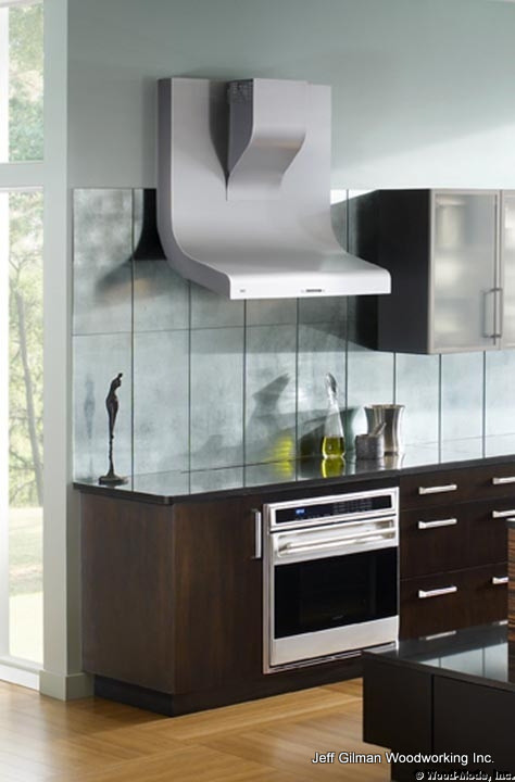 Example of a trendy galley eat-in kitchen design in Calgary with an undermount sink, flat-panel cabinets, dark wood cabinets, quartz countertops, gray backsplash and stainless steel appliances