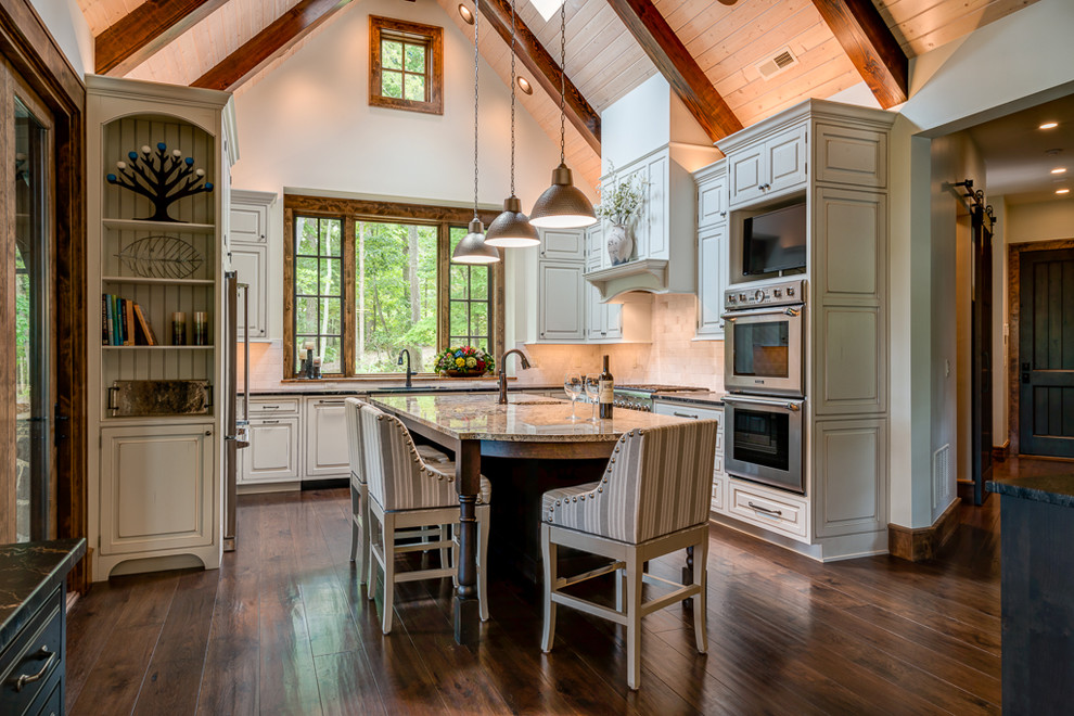 Inspiration for a rustic u-shaped dark wood floor and brown floor kitchen remodel in Other with raised-panel cabinets, gray cabinets, beige backsplash, stainless steel appliances, an island and black countertops