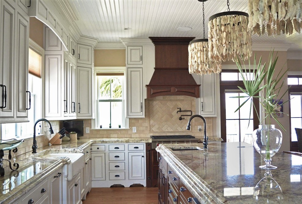 Example of a large classic eat-in kitchen design with a farmhouse sink, beaded inset cabinets, white cabinets, paneled appliances and an island