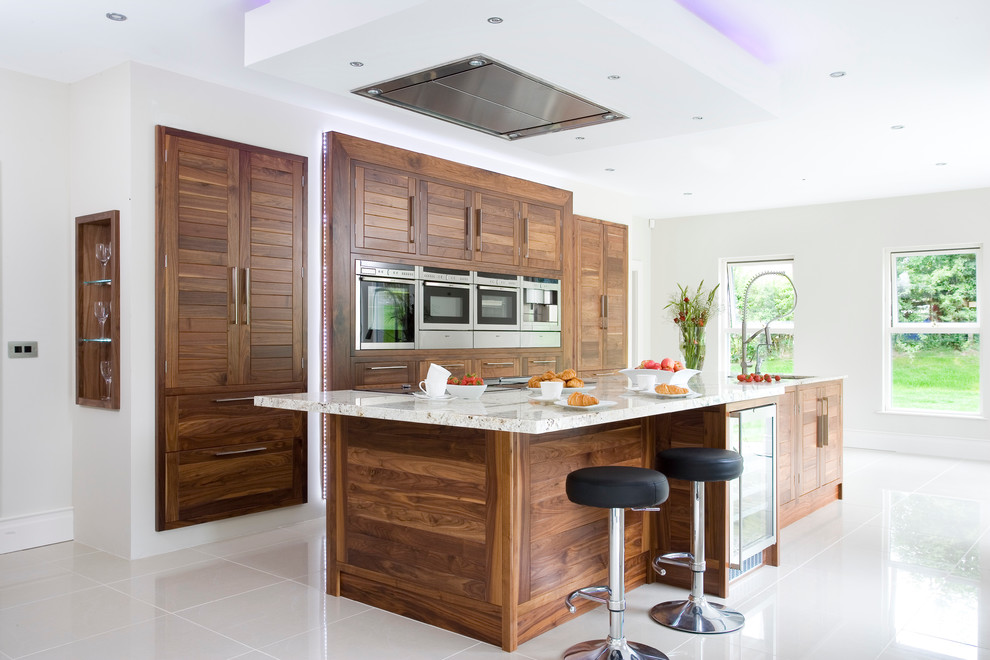Medium sized contemporary galley kitchen in Other with a submerged sink, flat-panel cabinets, dark wood cabinets, granite worktops, stainless steel appliances, porcelain flooring and an island.