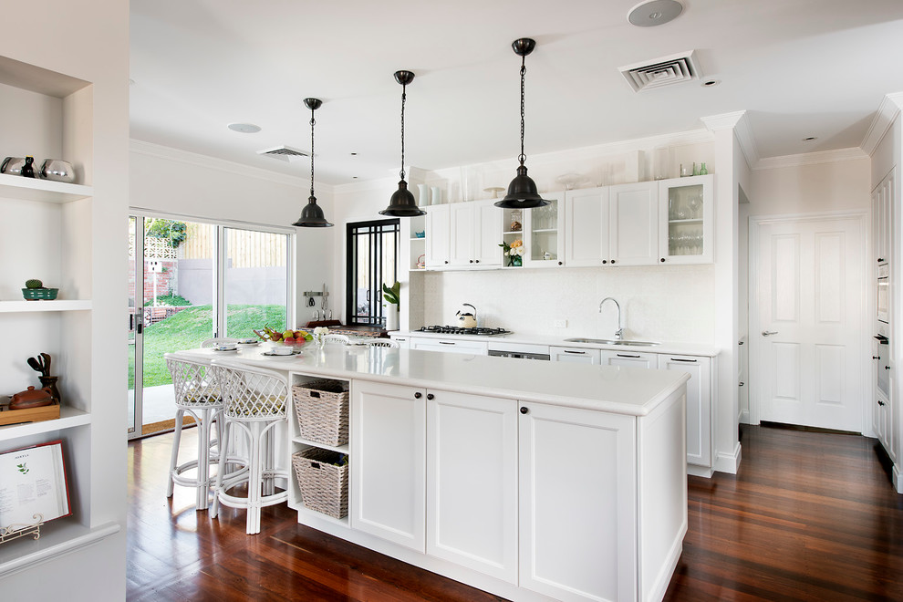 Example of a country galley dark wood floor open concept kitchen design in Perth with beaded inset cabinets, white cabinets, stainless steel appliances, an island and white backsplash