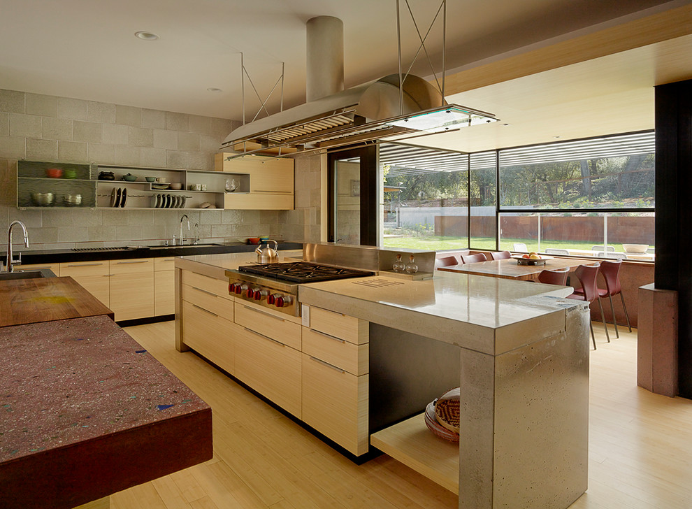 Large contemporary u-shaped kitchen/diner in San Francisco with light wood cabinets, concrete worktops and an island.