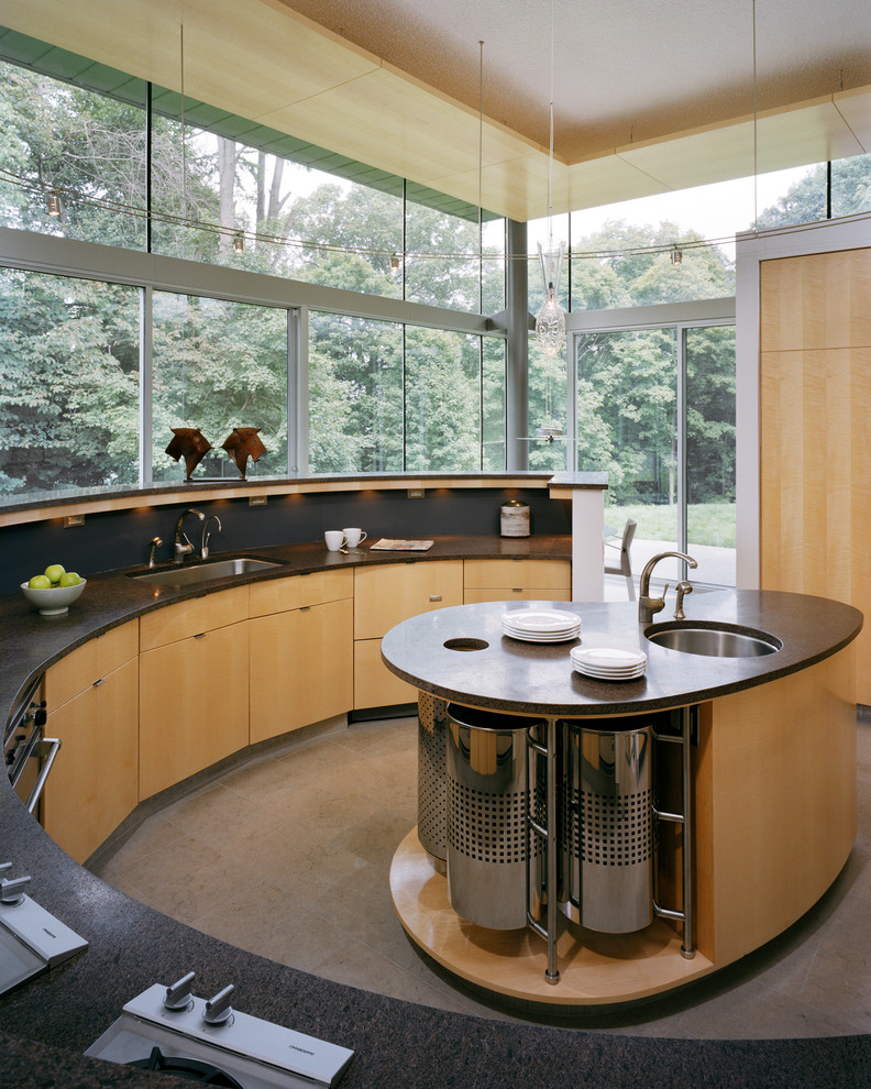 This is an example of a large contemporary u-shaped kitchen/diner in Philadelphia with a submerged sink, flat-panel cabinets, light wood cabinets, black splashback, an island, composite countertops, stone tiled splashback, black appliances, marble flooring, grey floors and a wood ceiling.