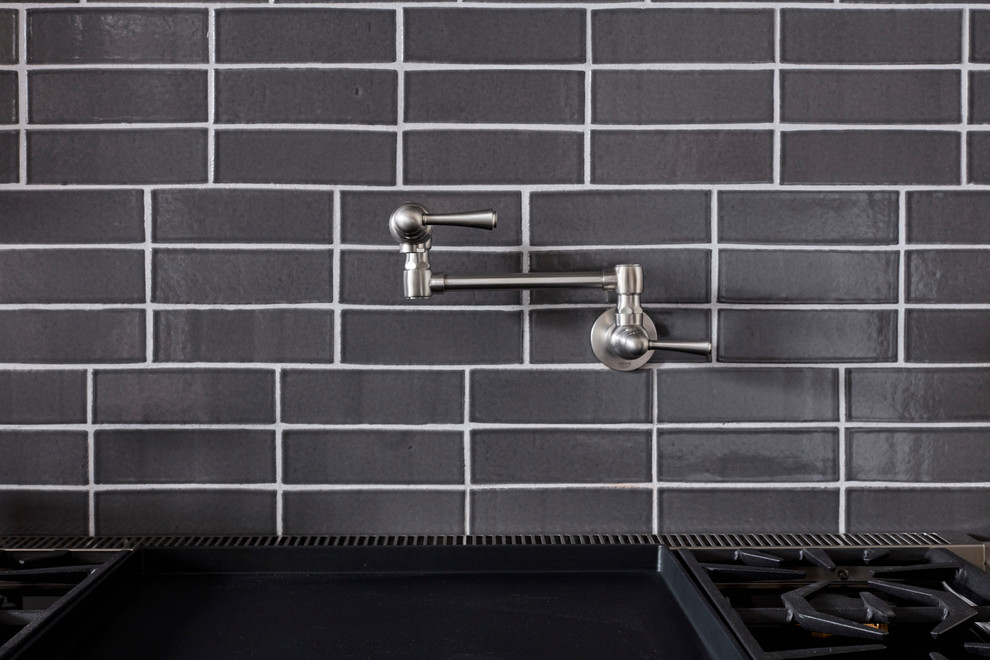 Example of a trendy kitchen design in San Francisco with gray backsplash, brick backsplash and two islands