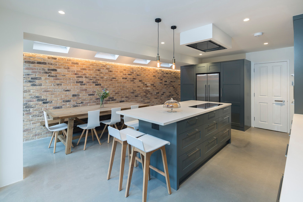 Design ideas for a medium sized modern kitchen in West Midlands with recessed-panel cabinets, grey cabinets, stainless steel appliances, concrete flooring, grey floors and white worktops.