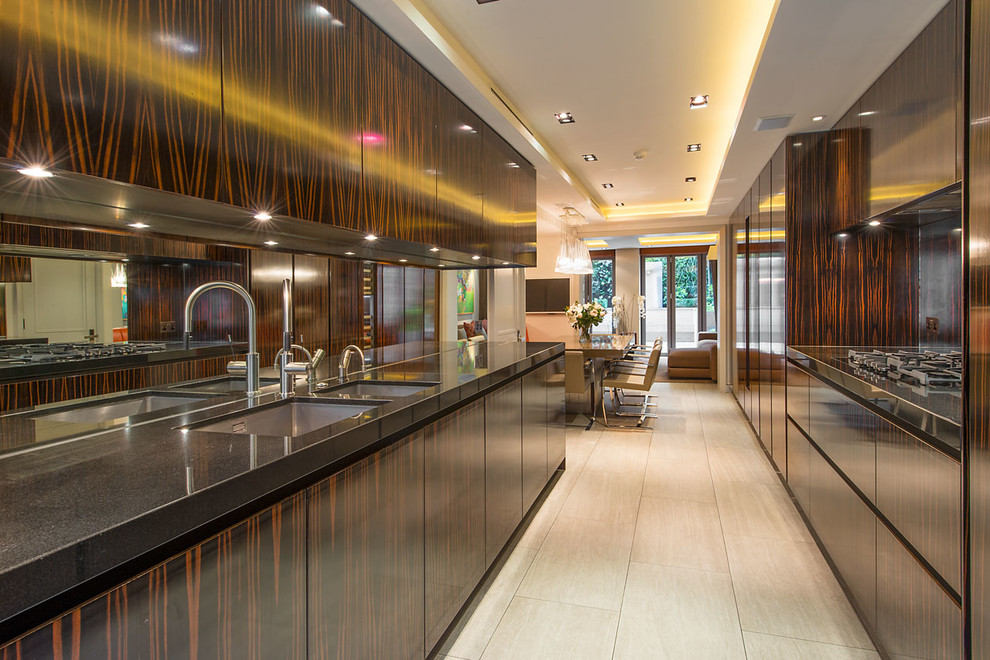 Contemporary kitchen/diner in London with a submerged sink, flat-panel cabinets and dark wood cabinets.