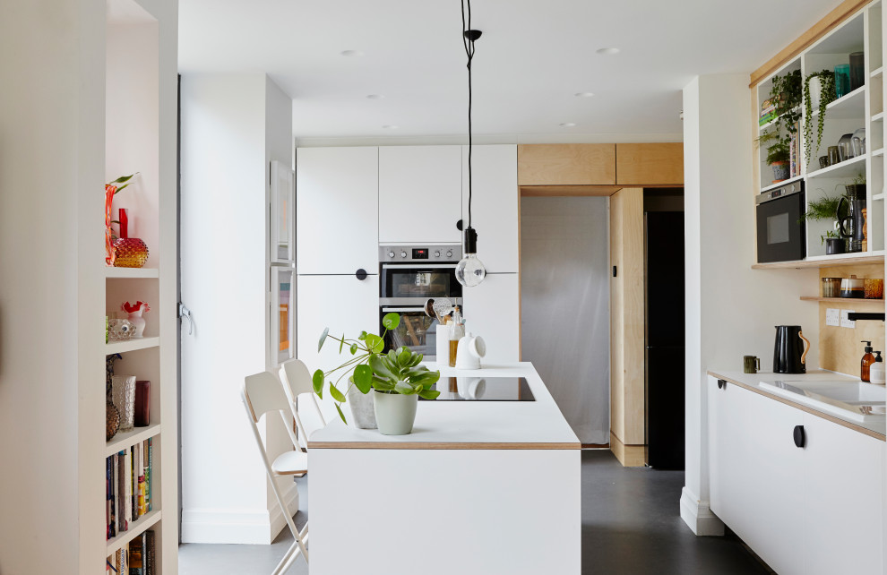 Medium sized contemporary u-shaped kitchen in London with a built-in sink, flat-panel cabinets, white cabinets, beige splashback, wood splashback, an island, grey floors and white worktops.