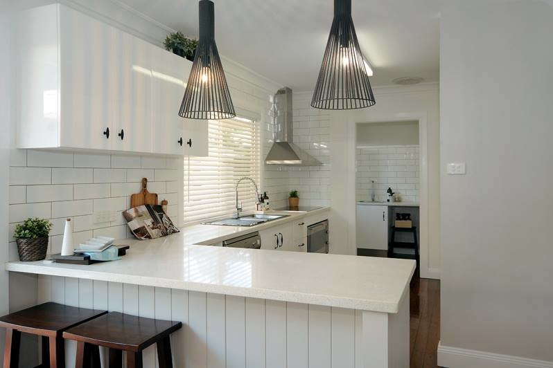This is an example of a medium sized modern l-shaped kitchen in Brisbane.