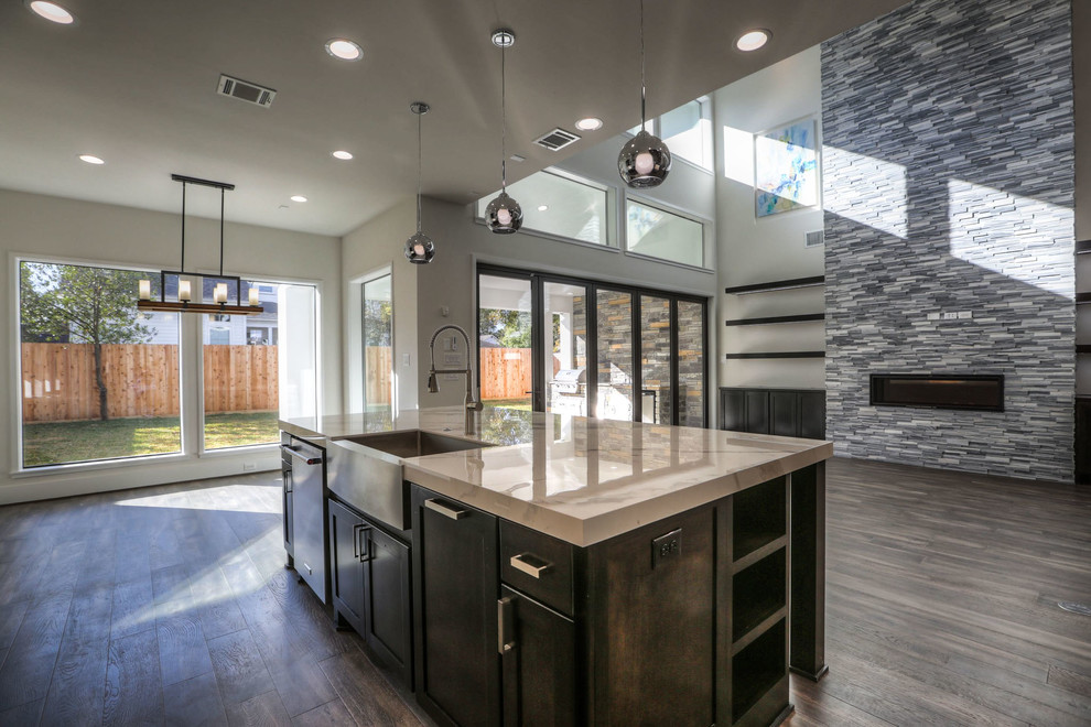 Large minimalist l-shaped dark wood floor and gray floor open concept kitchen photo in Houston with an undermount sink, recessed-panel cabinets, dark wood cabinets, quartz countertops, white backsplash, ceramic backsplash, stainless steel appliances and an island