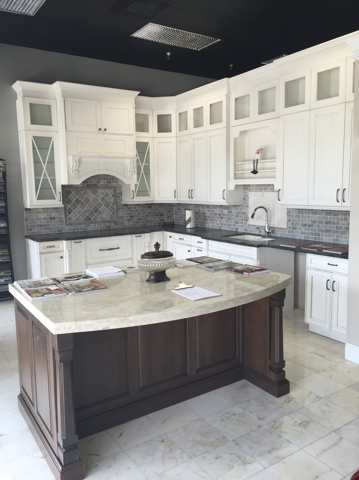 Photo of a large traditional u-shaped kitchen/diner in Houston with a double-bowl sink, recessed-panel cabinets, white cabinets, marble worktops, grey splashback, stainless steel appliances, marble flooring and an island.