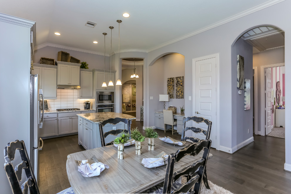 Example of a mid-sized l-shaped dark wood floor and purple floor eat-in kitchen design in Houston with a double-bowl sink, recessed-panel cabinets, gray cabinets, granite countertops, white backsplash, subway tile backsplash, stainless steel appliances and an island