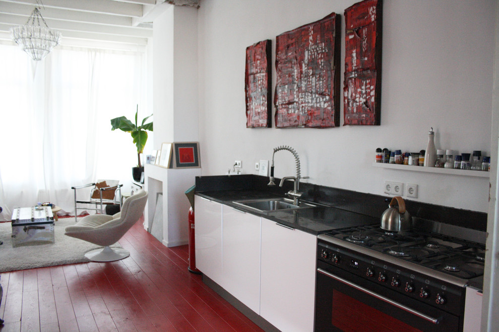 Bohemian kitchen in Amsterdam with red floors.
