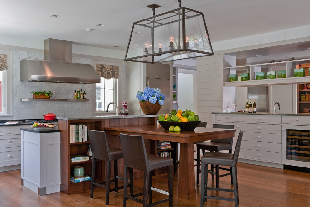 Example of a trendy eat-in kitchen design in Boston with stainless steel appliances, stone tile backsplash, white cabinets and white backsplash
