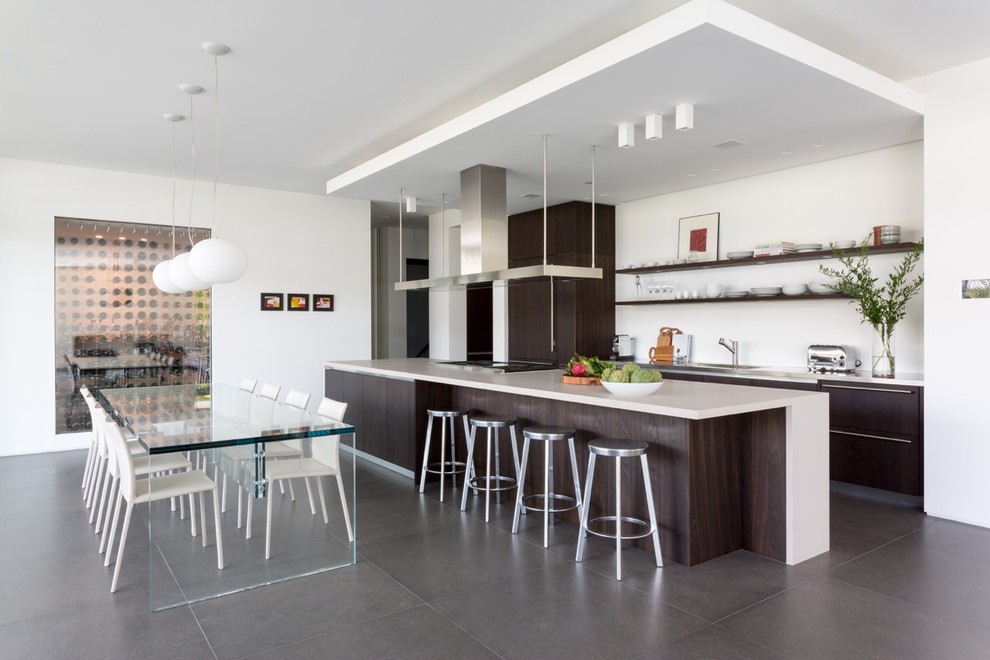 Example of a trendy galley eat-in kitchen design in Miami with an undermount sink, flat-panel cabinets, dark wood cabinets, quartz countertops, white backsplash, stainless steel appliances and an island