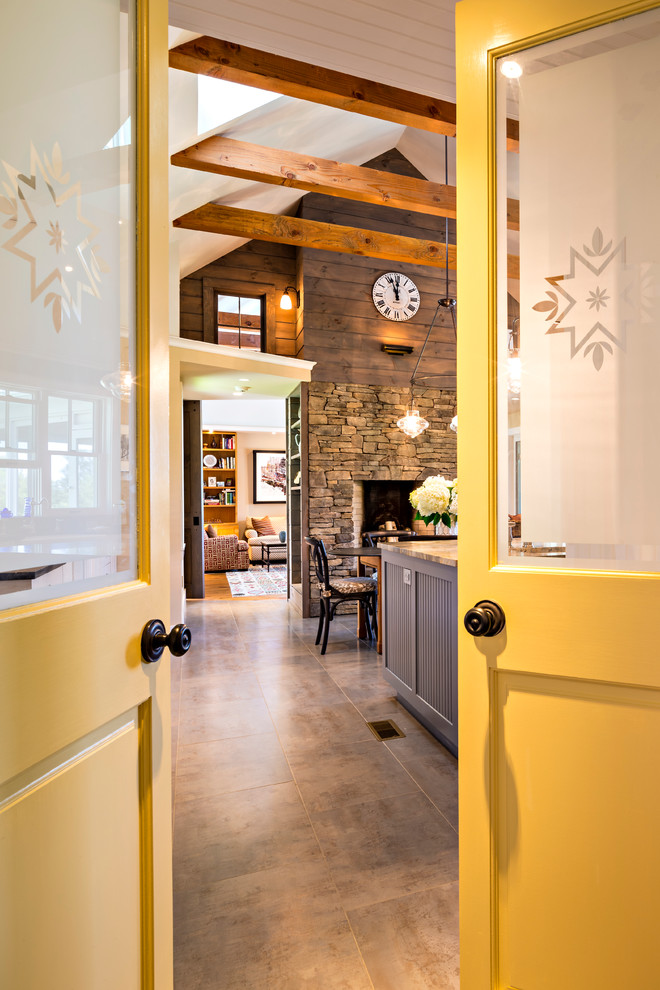 Example of a huge country galley eat-in kitchen design in New York with a farmhouse sink, beaded inset cabinets, gray cabinets, multicolored backsplash, glass tile backsplash, paneled appliances and an island