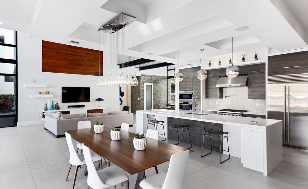 Inspiration for a large contemporary porcelain tile and gray floor open concept kitchen remodel in Tampa with an undermount sink, flat-panel cabinets, dark wood cabinets, quartz countertops, stainless steel appliances, an island, white countertops and white backsplash