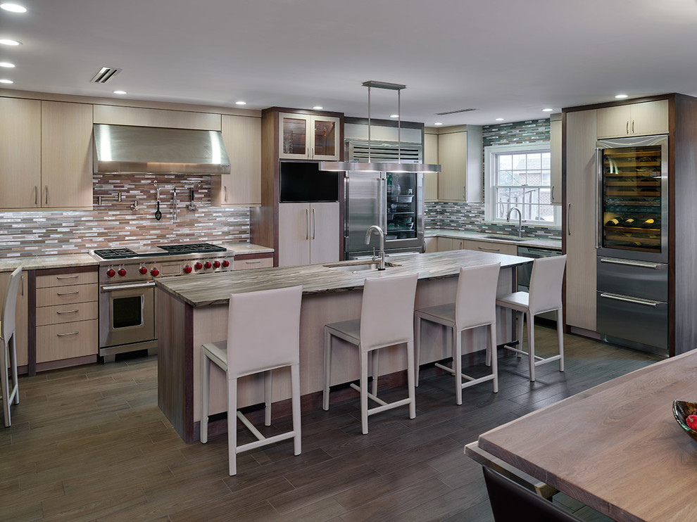 Photo of a large contemporary u-shaped kitchen/diner in Philadelphia with a submerged sink, flat-panel cabinets, medium wood cabinets, granite worktops, metallic splashback, metal splashback, stainless steel appliances, porcelain flooring and an island.