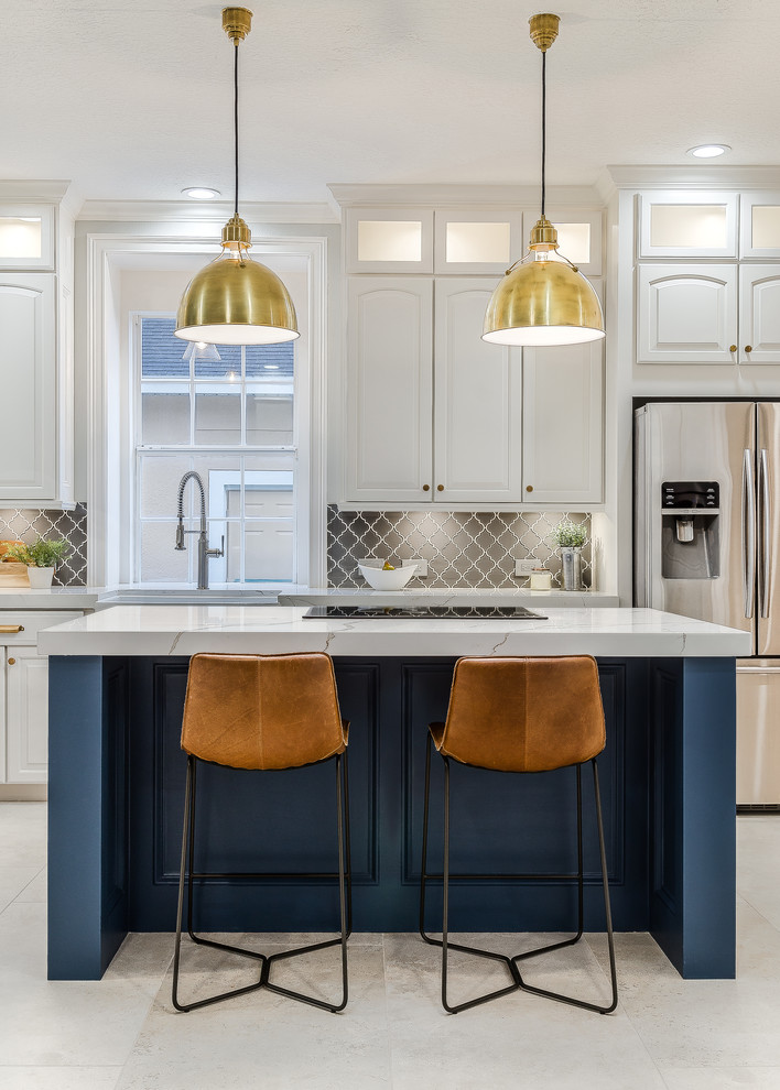 Transitional galley white floor kitchen photo in Orlando with raised-panel cabinets, white cabinets, gray backsplash, stainless steel appliances, an island and white countertops