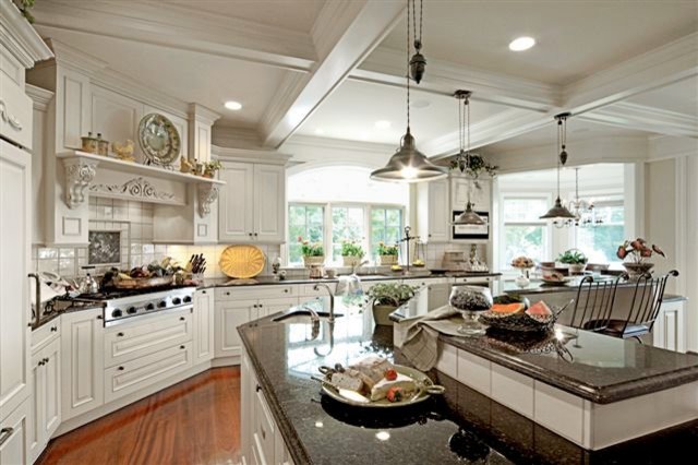 Eat-in kitchen - traditional u-shaped medium tone wood floor eat-in kitchen idea in New York with an undermount sink, raised-panel cabinets, white cabinets, granite countertops, white backsplash, ceramic backsplash, white appliances and an island