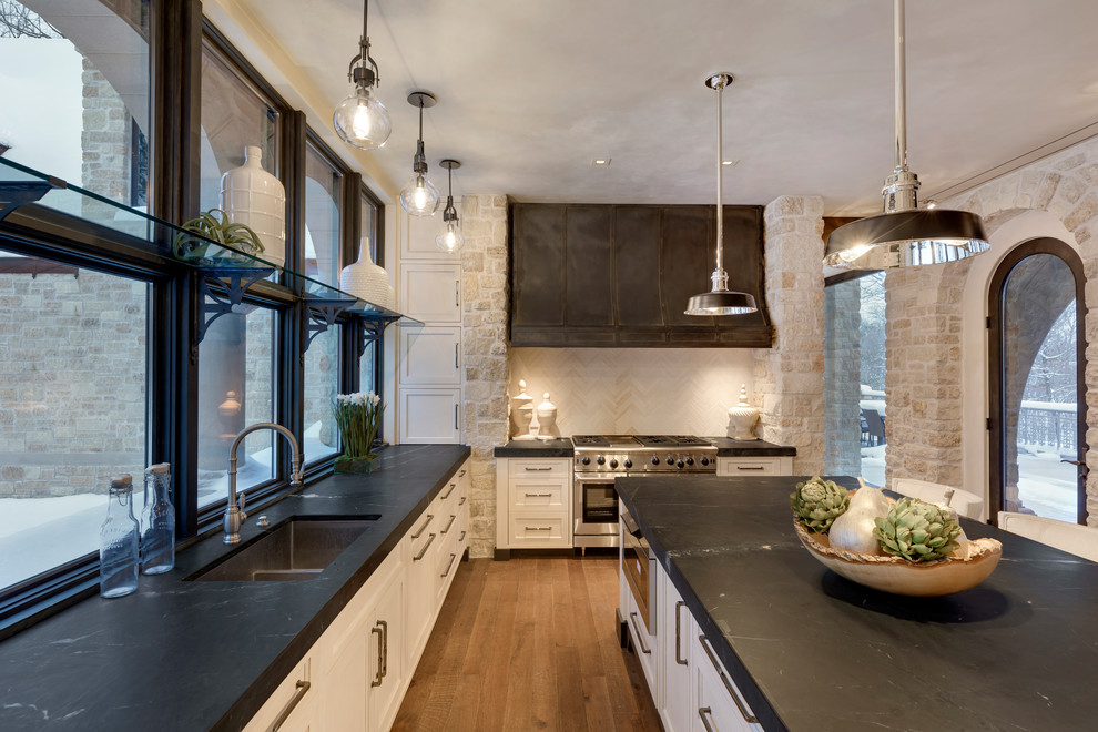 Inspiration for a traditional kitchen in Minneapolis with white cabinets and an island.