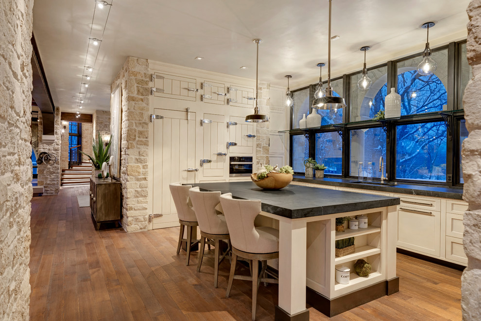 Example of a classic kitchen design in Minneapolis with white cabinets and an island