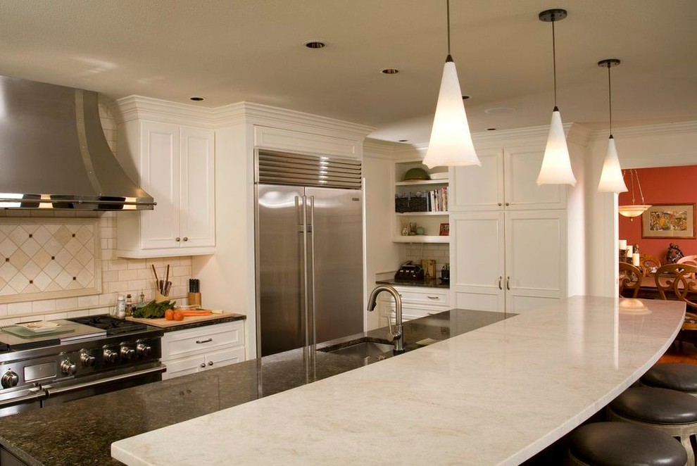 Inspiration for a mid-sized timeless l-shaped enclosed kitchen remodel in Seattle with an undermount sink, recessed-panel cabinets, white cabinets, white backsplash, subway tile backsplash, stainless steel appliances, an island and quartz countertops