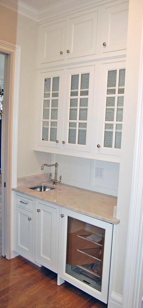 Exempel på ett stort klassiskt kök, med en undermonterad diskho, luckor med profilerade fronter, vita skåp, rostfria vitvaror, mellanmörkt trägolv och en köksö
