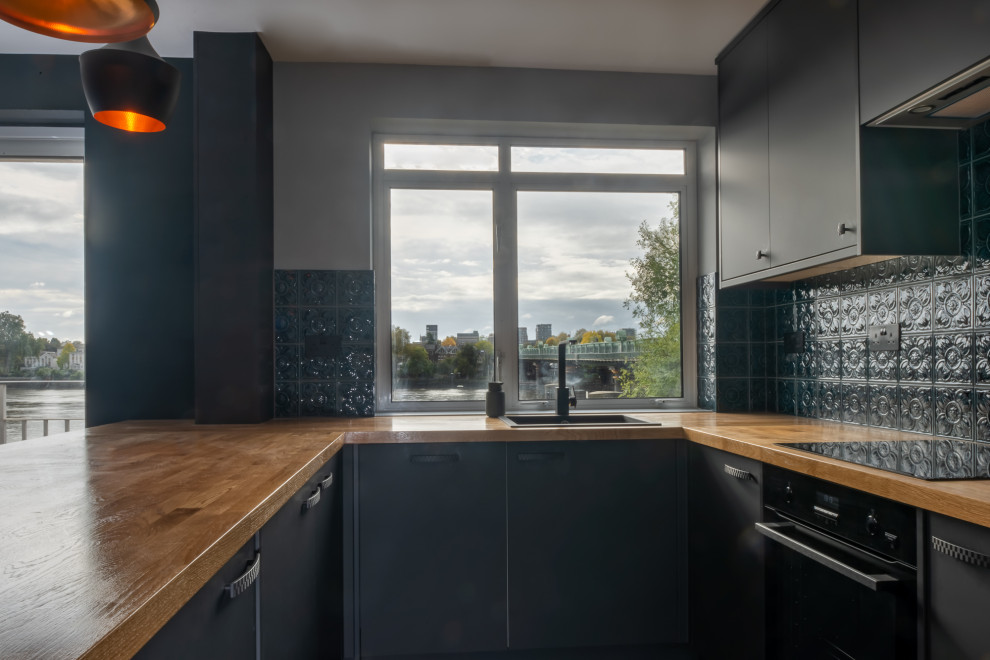 Photo of a medium sized modern kitchen/diner in London with an island and grey floors.