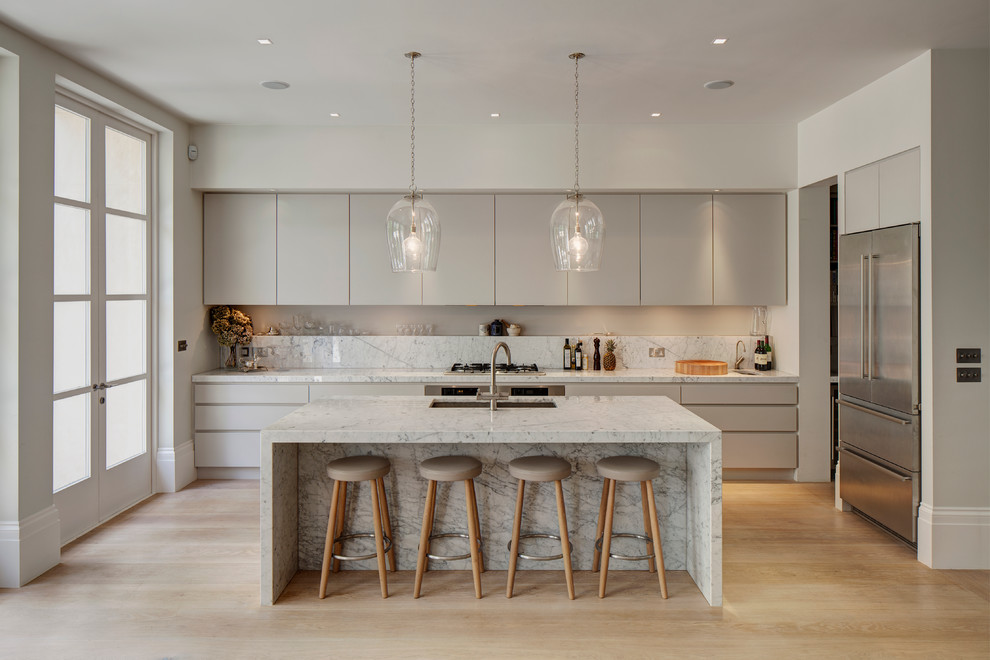 Immagine di una cucina contemporanea con paraspruzzi in marmo