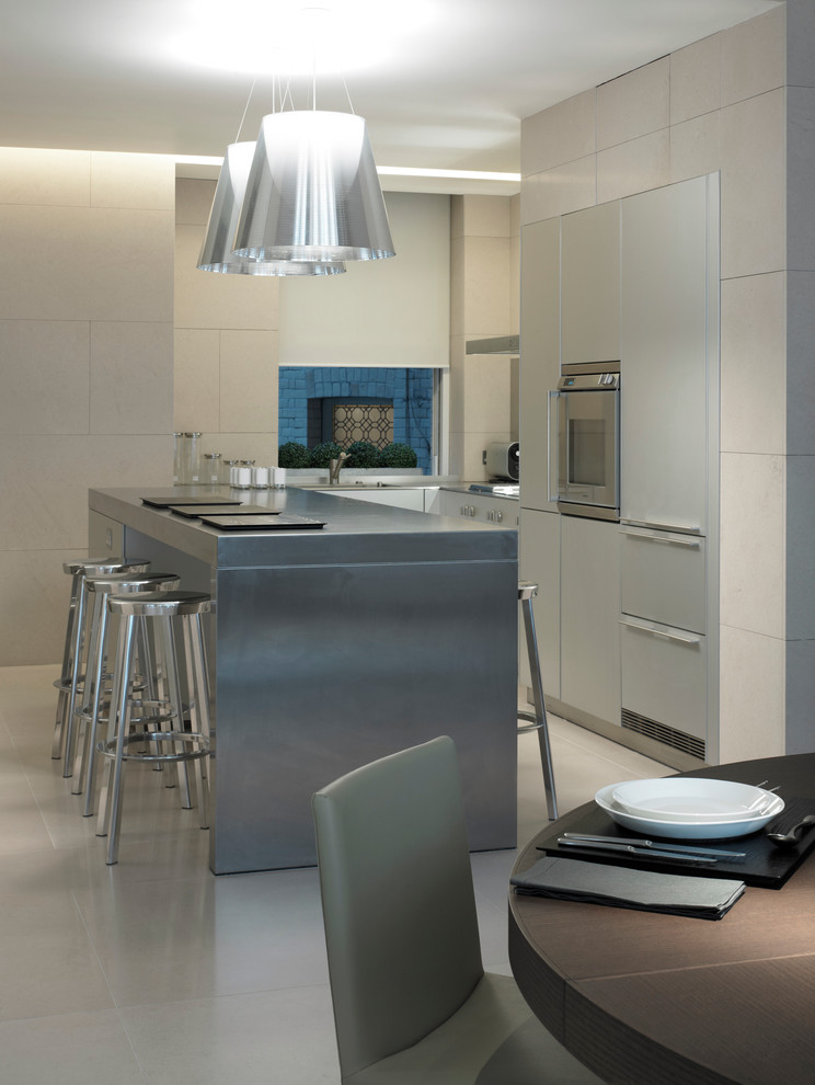 Photo of a medium sized contemporary u-shaped open plan kitchen in London with a double-bowl sink, flat-panel cabinets, grey cabinets, granite worktops, metallic splashback, metal splashback, stainless steel appliances, limestone flooring and an island.